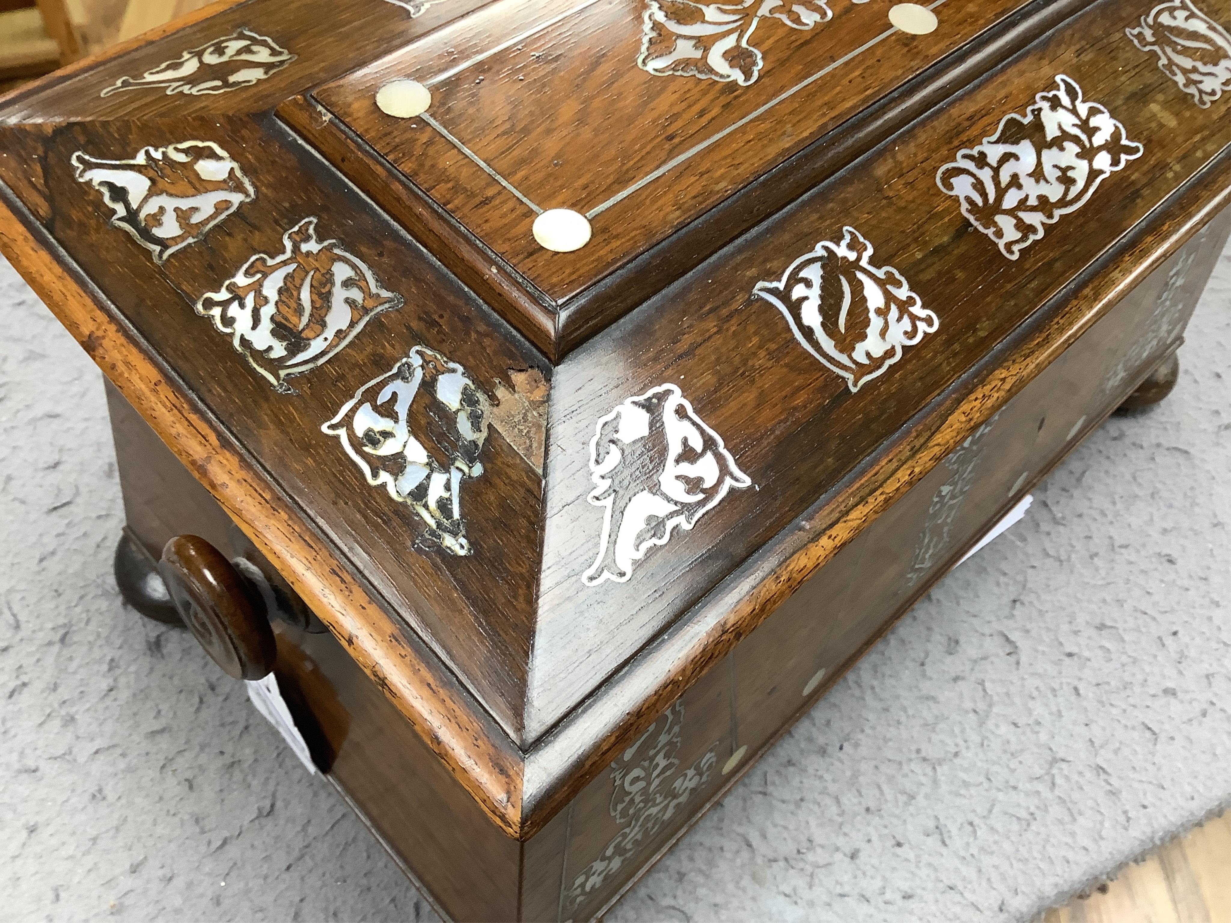 A Victorian rosewood and mother-of-pearl inlaid sarcophagus tea caddy, 39cm wide. Condition - fair